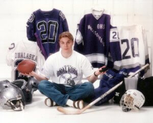 Robin Finco in front of football and hockey gear