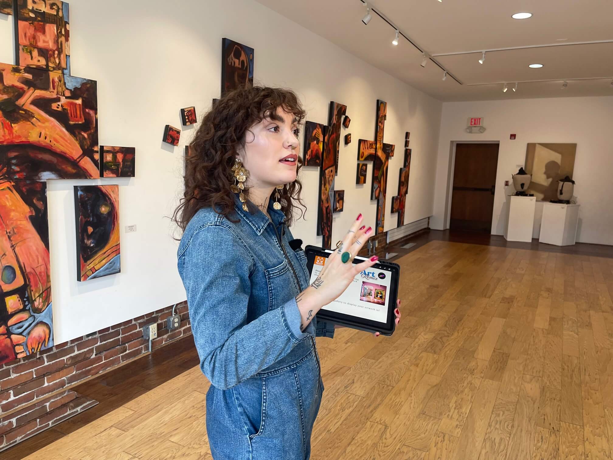 Woman demonstrating a creative arts program on an iPad for neurodivergent youth and young adults.
