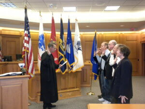 Retired Judge Todd Bjerke swears in new mentors for the La Crosse Area Veterans Mentor Program.