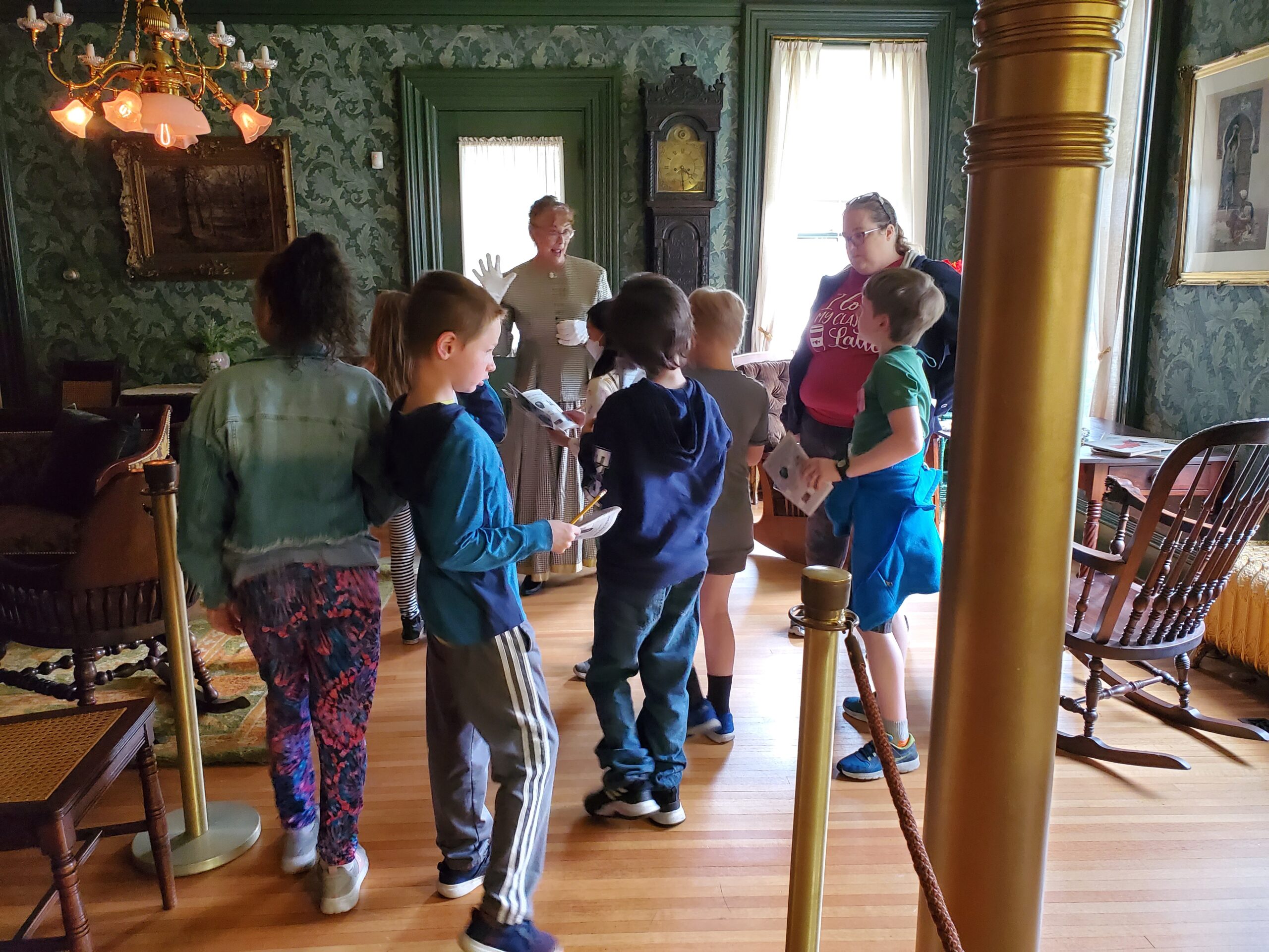 Hixon House docent Cathy Walth helping second-graders find things in Hixon House featured in their "Museum Passport."