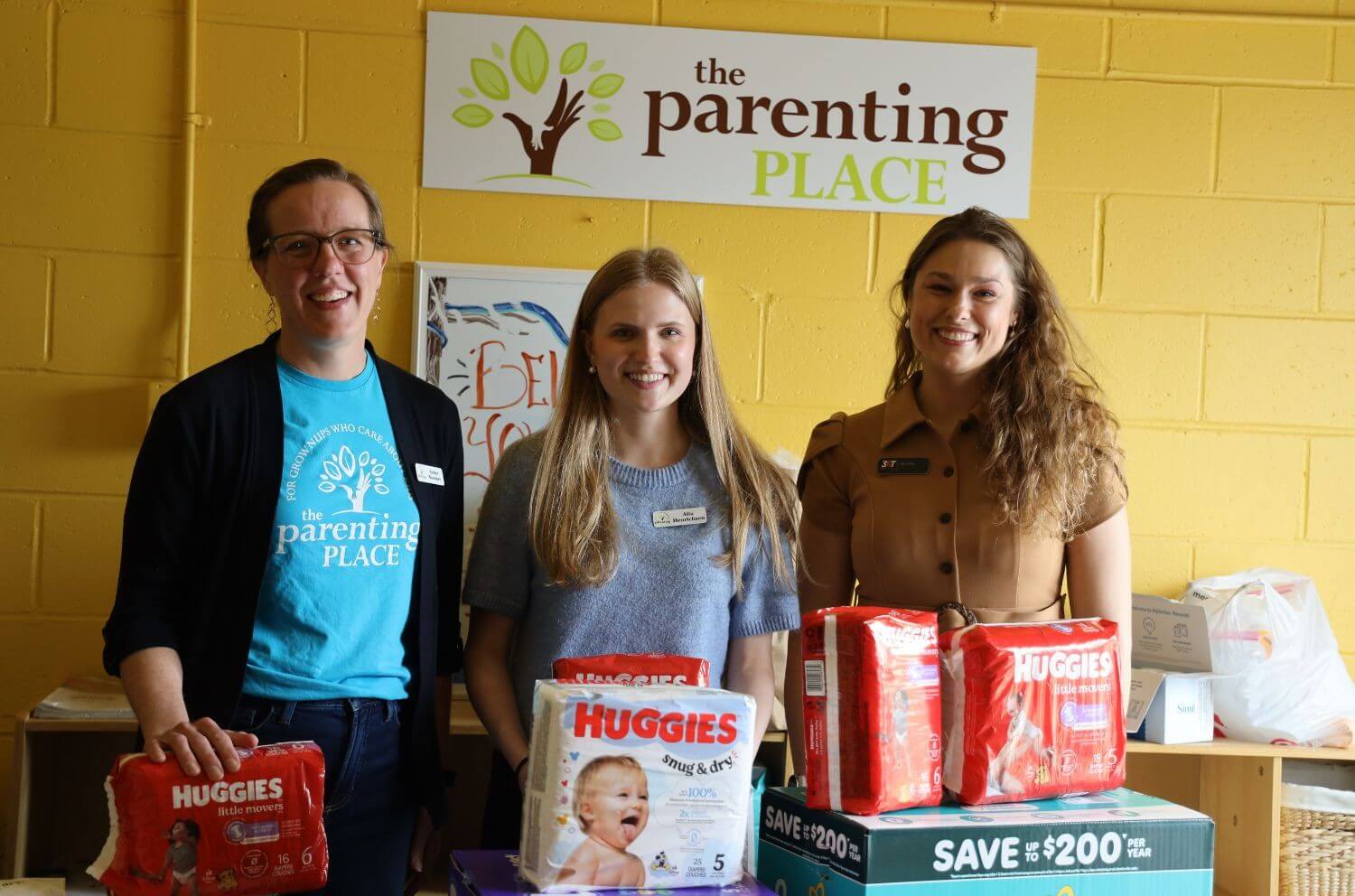 three women with donated diapers at The Parenting Place