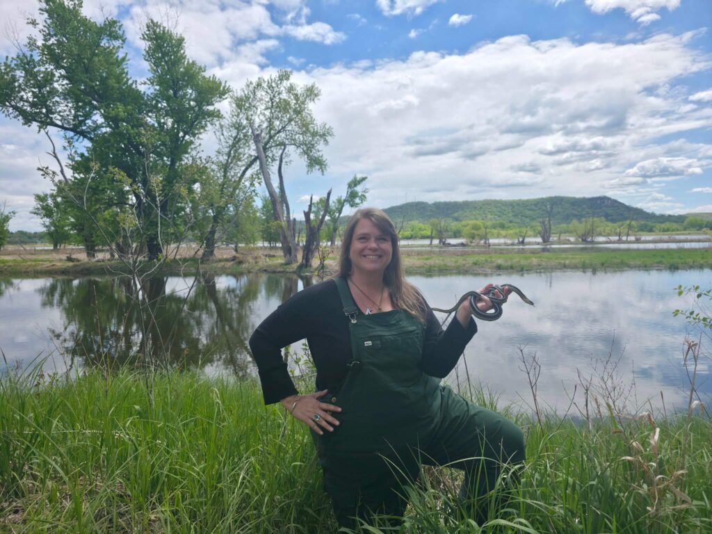 Angela Subjek, founder and executive director of Bluff Country Snakes, poses with Simon and Sunny, paired female garter snakes