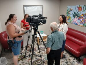 woman speaks to reporters