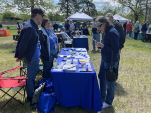 Alex Wieser and Jade Butler (l-r) share information about services available at the Aging and Disability Resource Center with community members at this year’s Community Picnic in Recognition of Older Americans Month at Veterans Memorial Park in West Salem.
