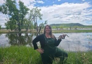Angela Subjek, founder and executive director of Bluff Country Snakes, poses with Simon and Sunny, paired female garter snakes