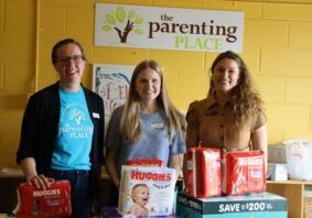 three women with donated diapers at The Parenting Place